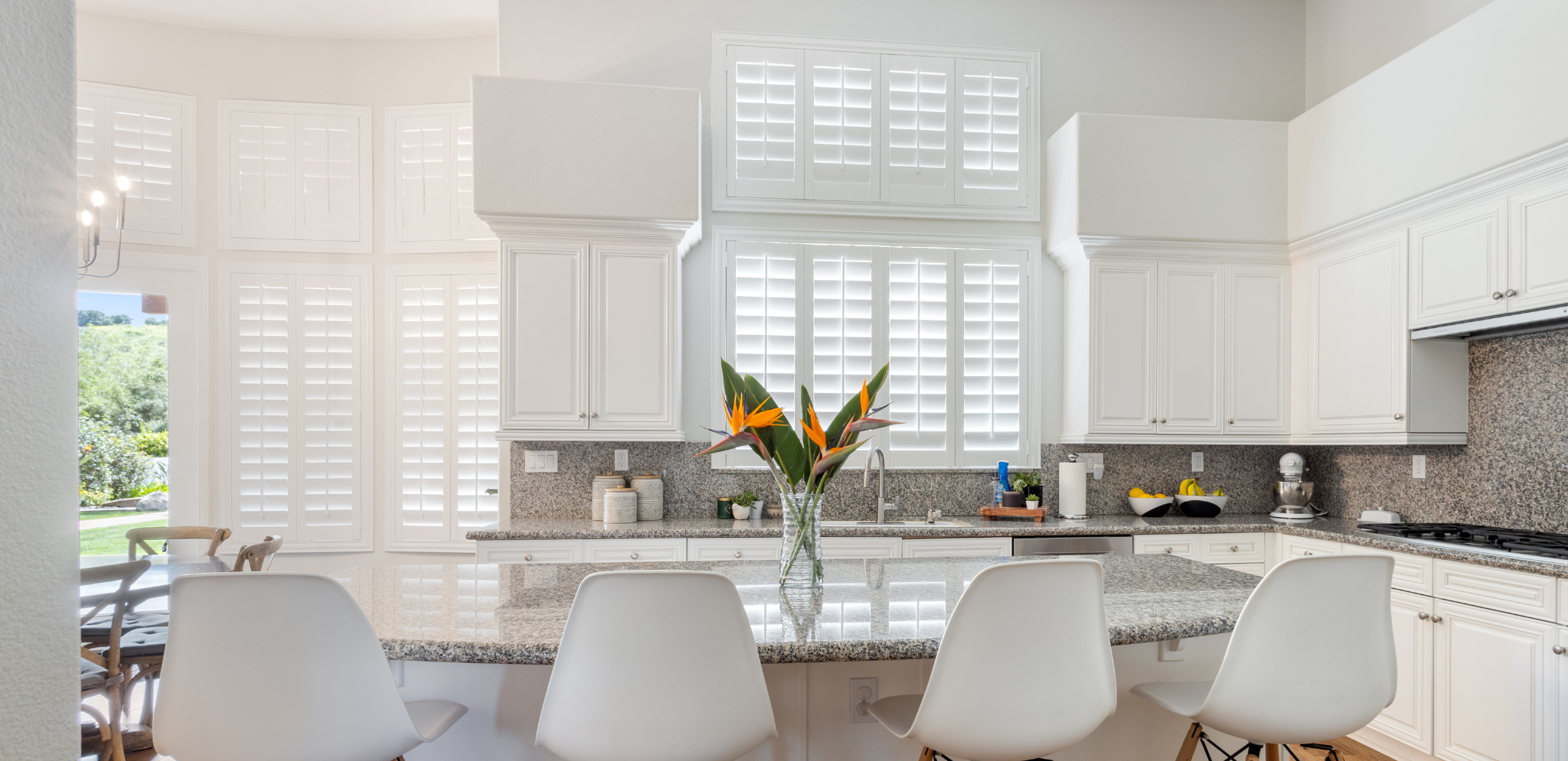 White shutters within a large window area.